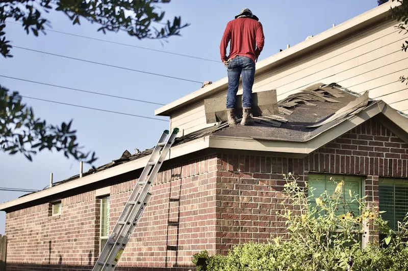 Professional roofer working on a residential roof in Barney Moose